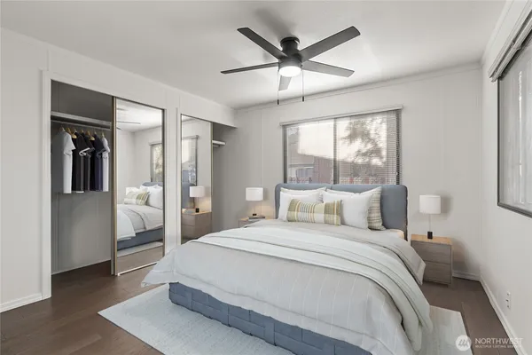 a bedroom with a large bed and a large window
