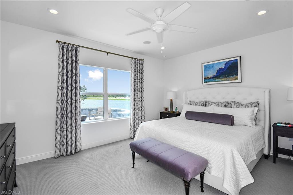 4621 Centaurus Circle Naples, FL 34120 - Photo 6 of 15 a spacious bedroom with a bed and a chandelier