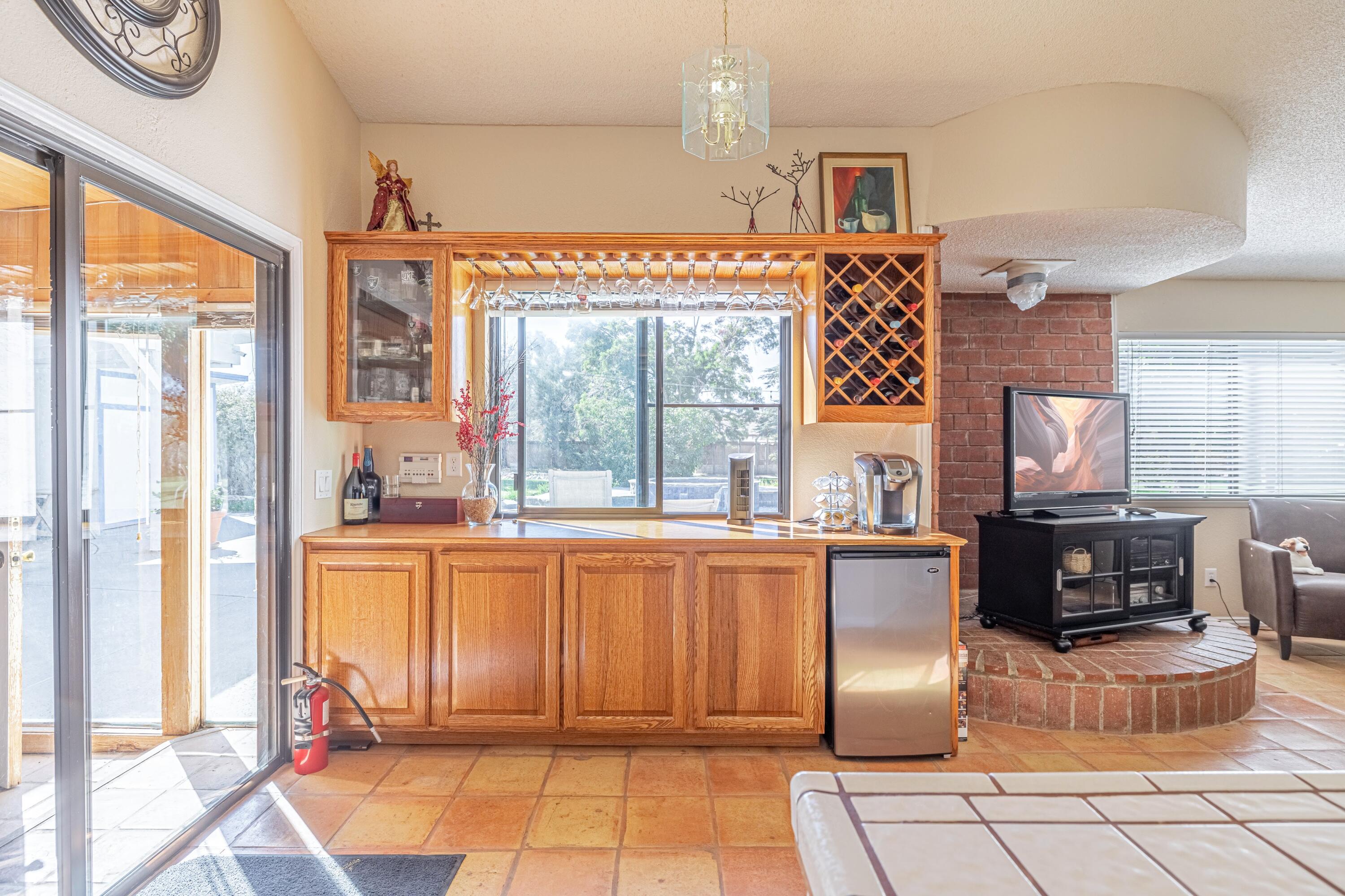 43233 55th Street East Lancaster, CA 93535 - Photo 16 of 46 a living room with furniture a large window and a fireplace