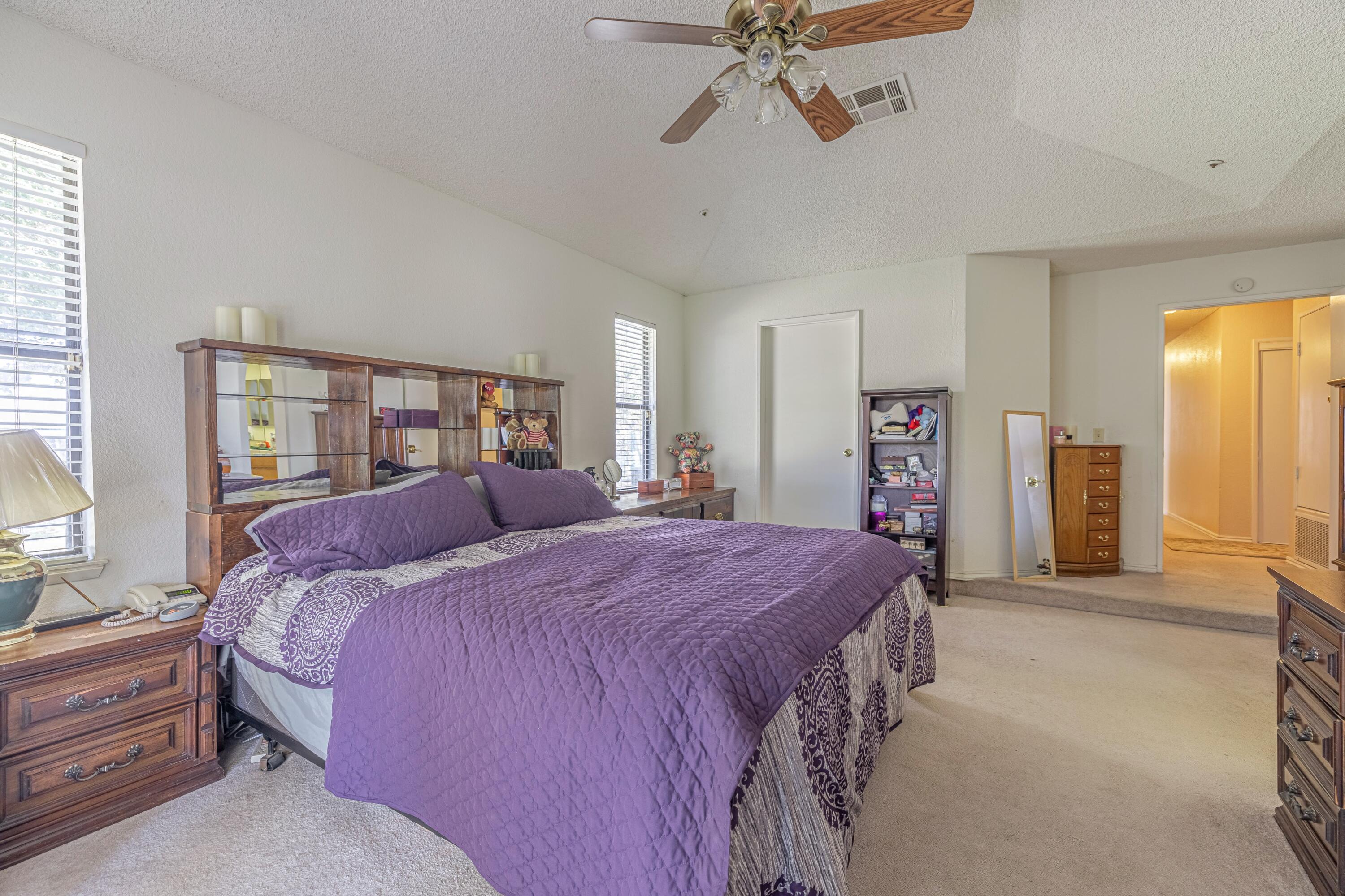 43233 55th Street East Lancaster, CA 93535 - Photo 19 of 46 a bed room with a bed and a chandelier