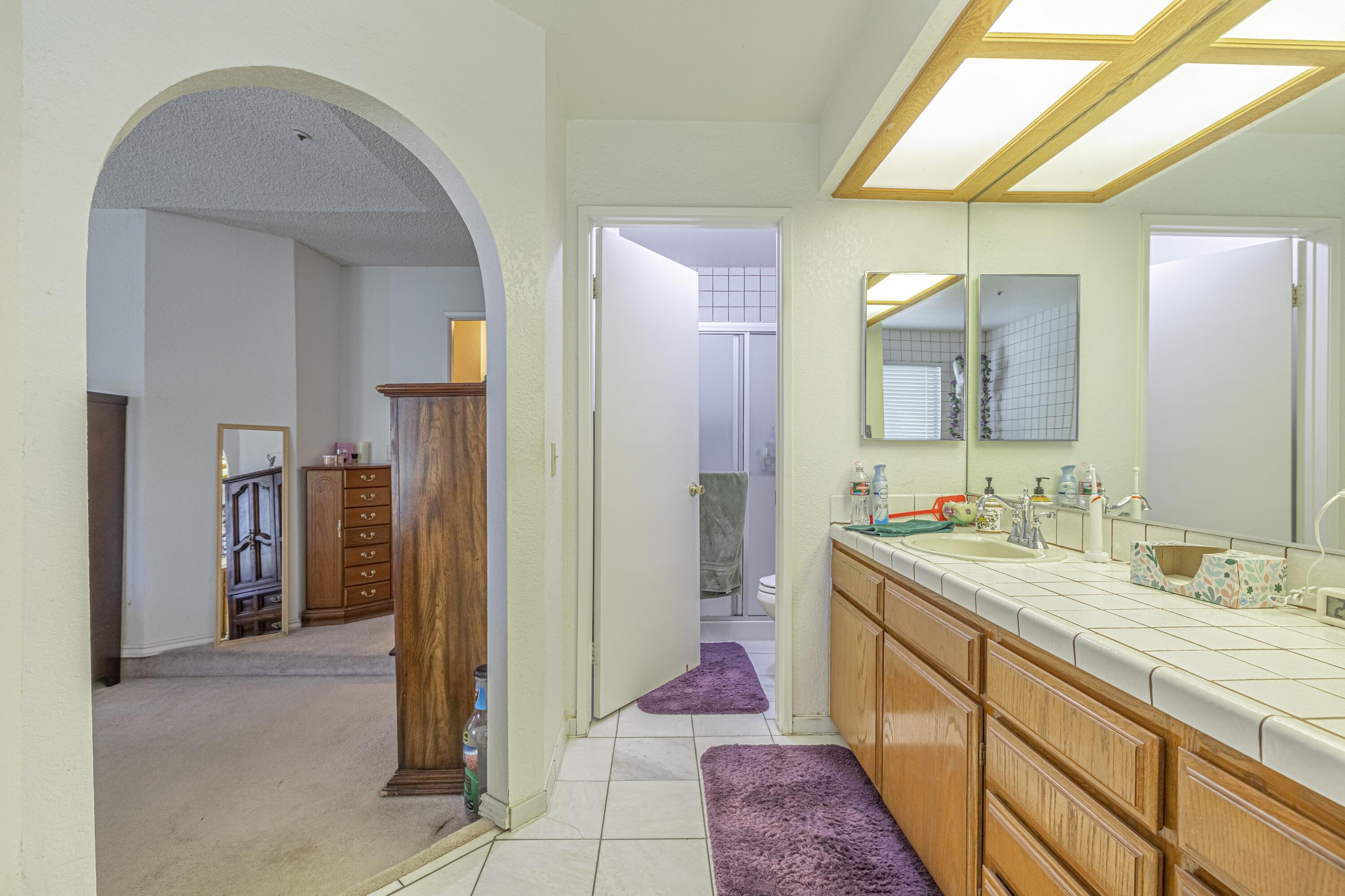 43233 55th Street East Lancaster, CA 93535 - Photo 22 of 46 a bathroom with a sink and a mirror