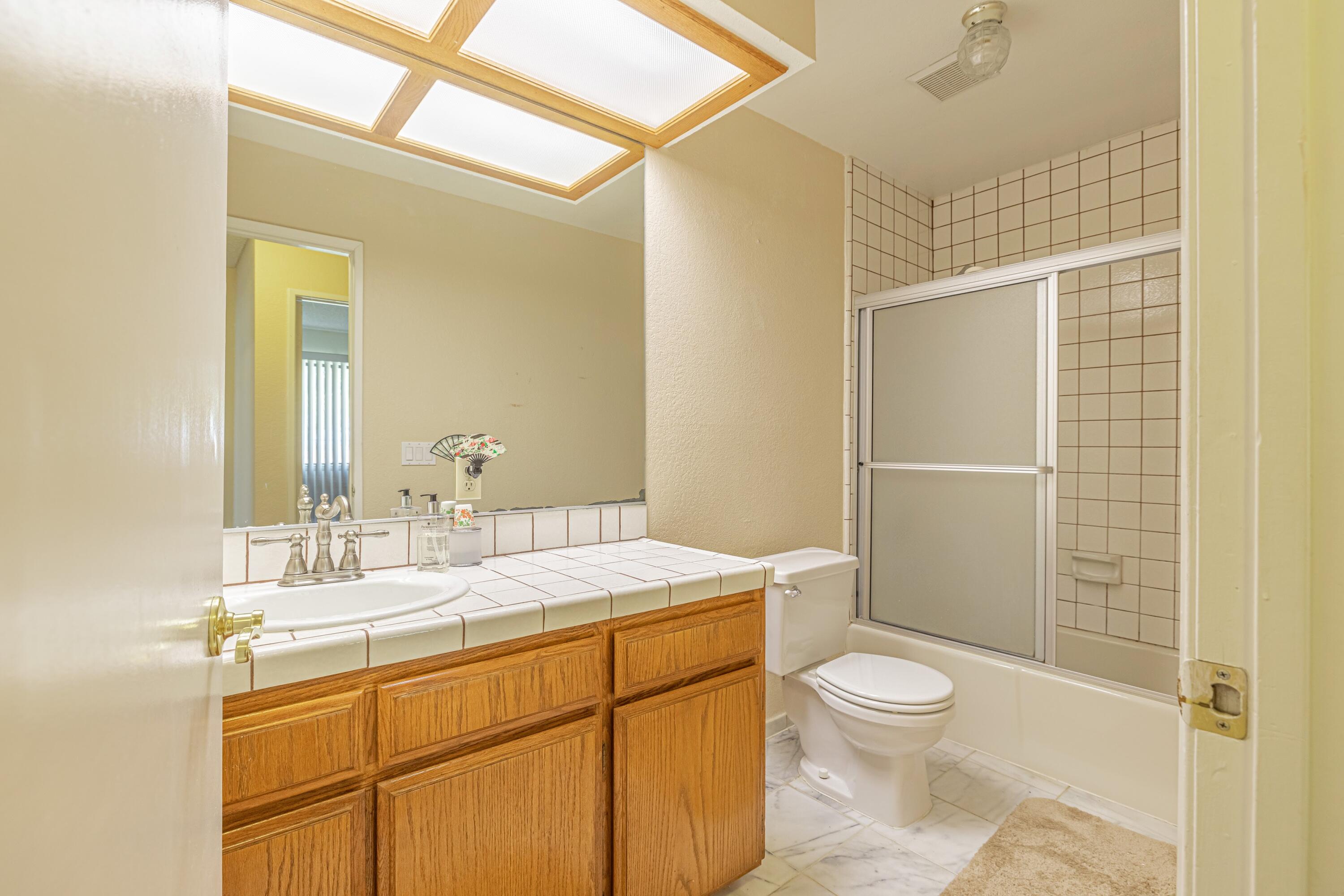 43233 55th Street East Lancaster, CA 93535 - Photo 26 of 46 a bathroom with a sink a toilet and shower