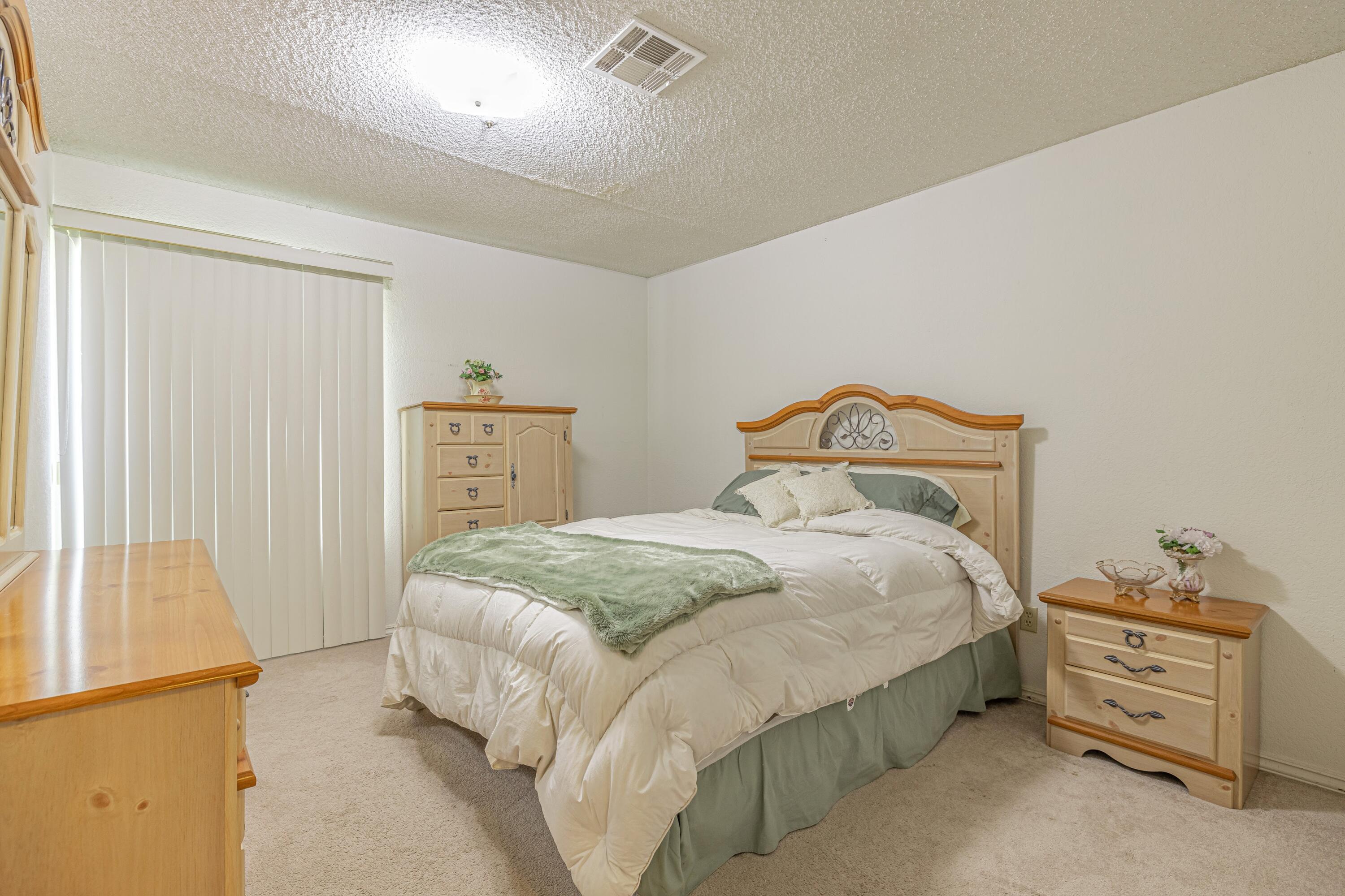 43233 55th Street East Lancaster, CA 93535 - Photo 27 of 46 a bedroom with a bed and cabinets