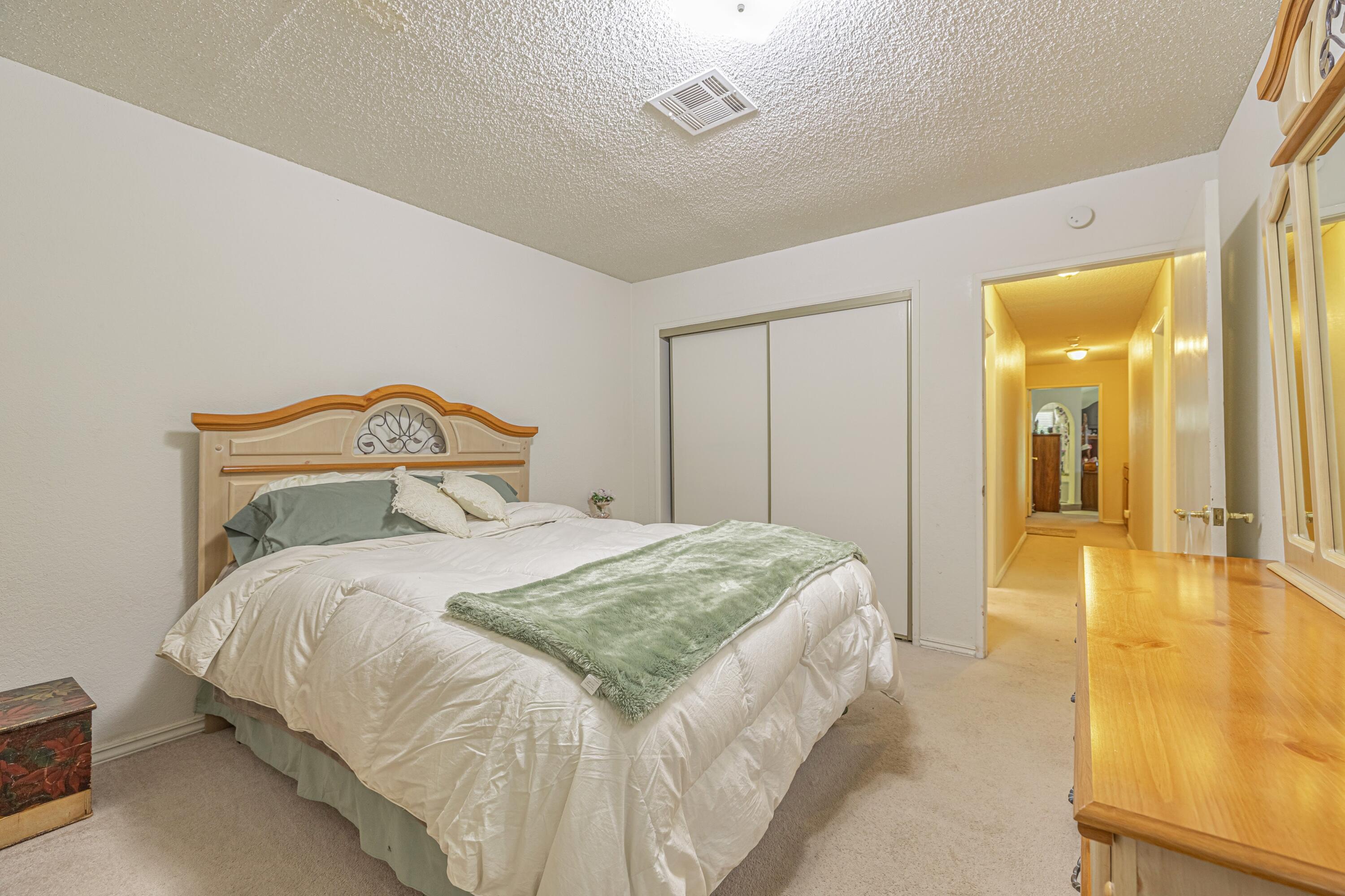 43233 55th Street East Lancaster, CA 93535 - Photo 28 of 46 a bedroom with a bed and a chandelier