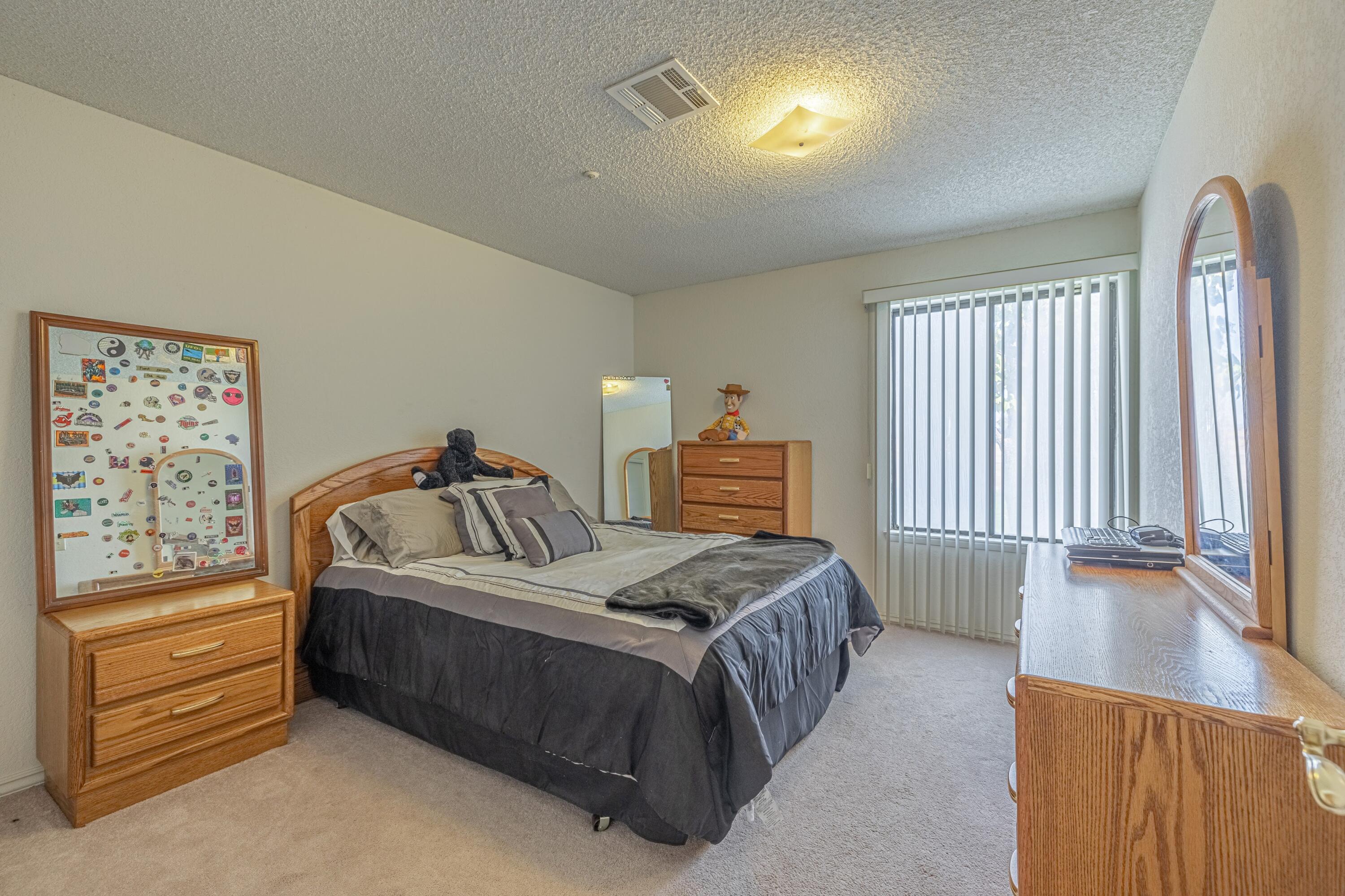 43233 55th Street East Lancaster, CA 93535 - Photo 29 of 46 a bedroom with a bed and a night stand