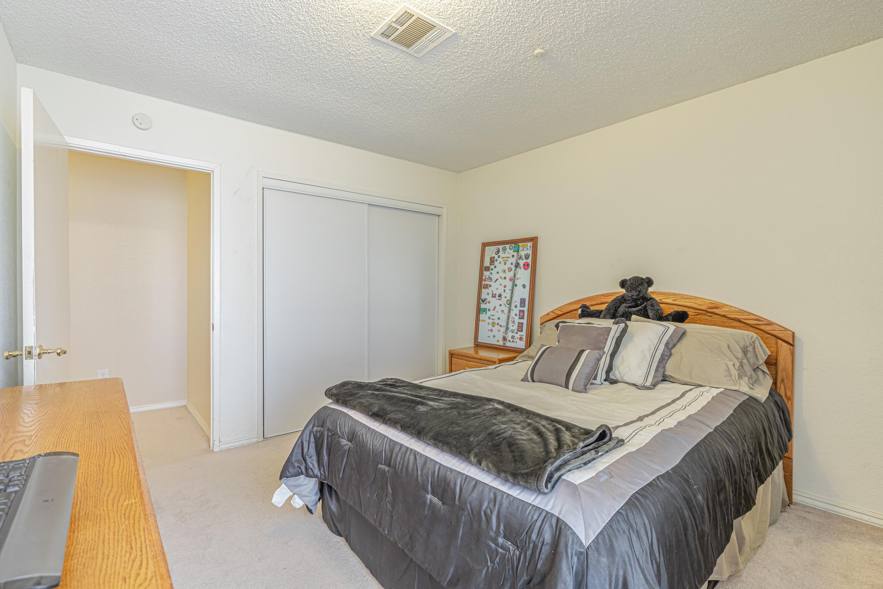 43233 55th Street East Lancaster, CA 93535 - Photo 30 of 46 a bedroom with a bed and wooden floor