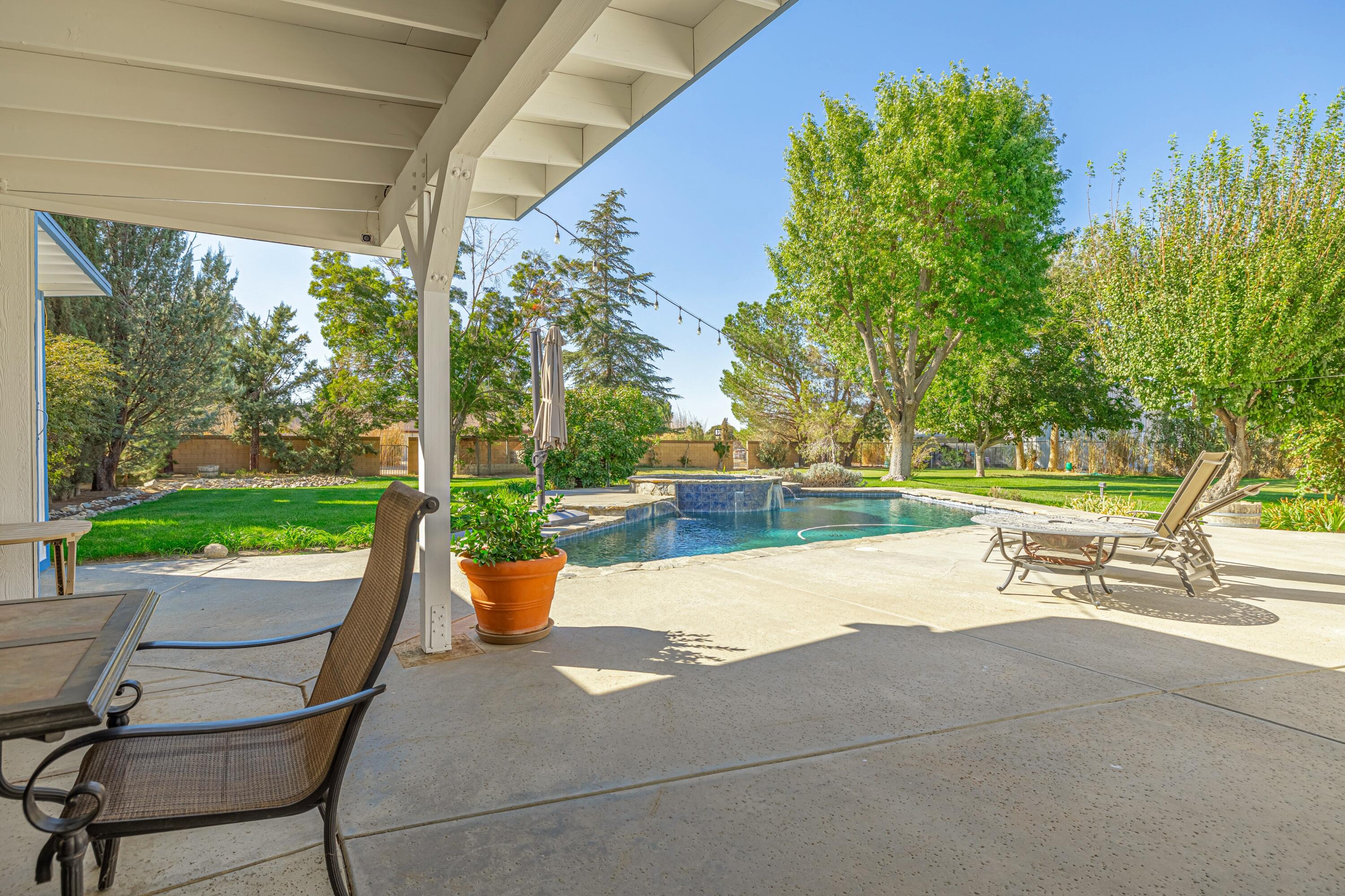 43233 55th Street East Lancaster, CA 93535 - Photo 33 of 46 a view of a patio with a dining table and chairs