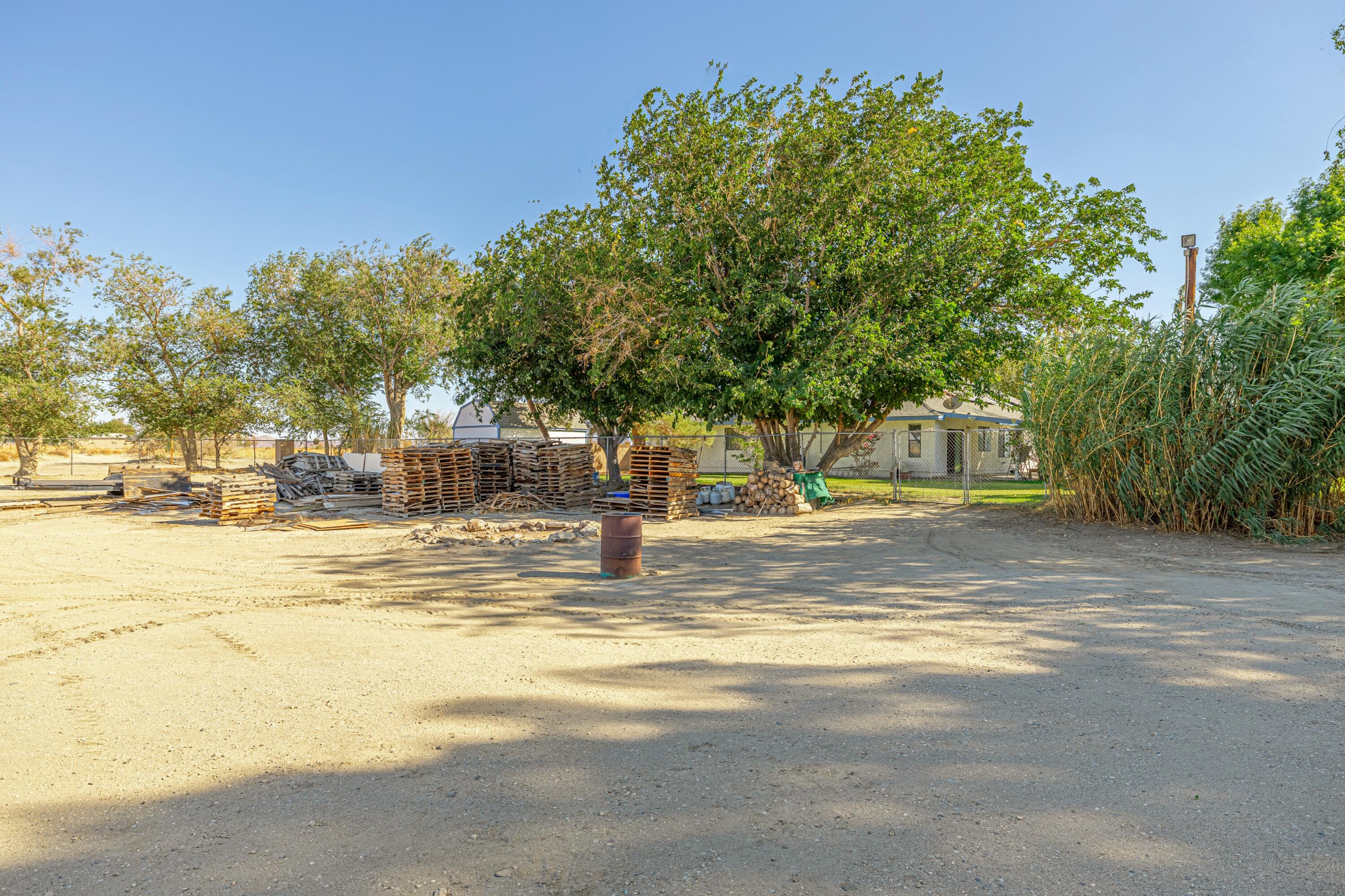 43233 55th Street East Lancaster, CA 93535 - Photo 42 of 46 a view of a swimming pool with a house in the background