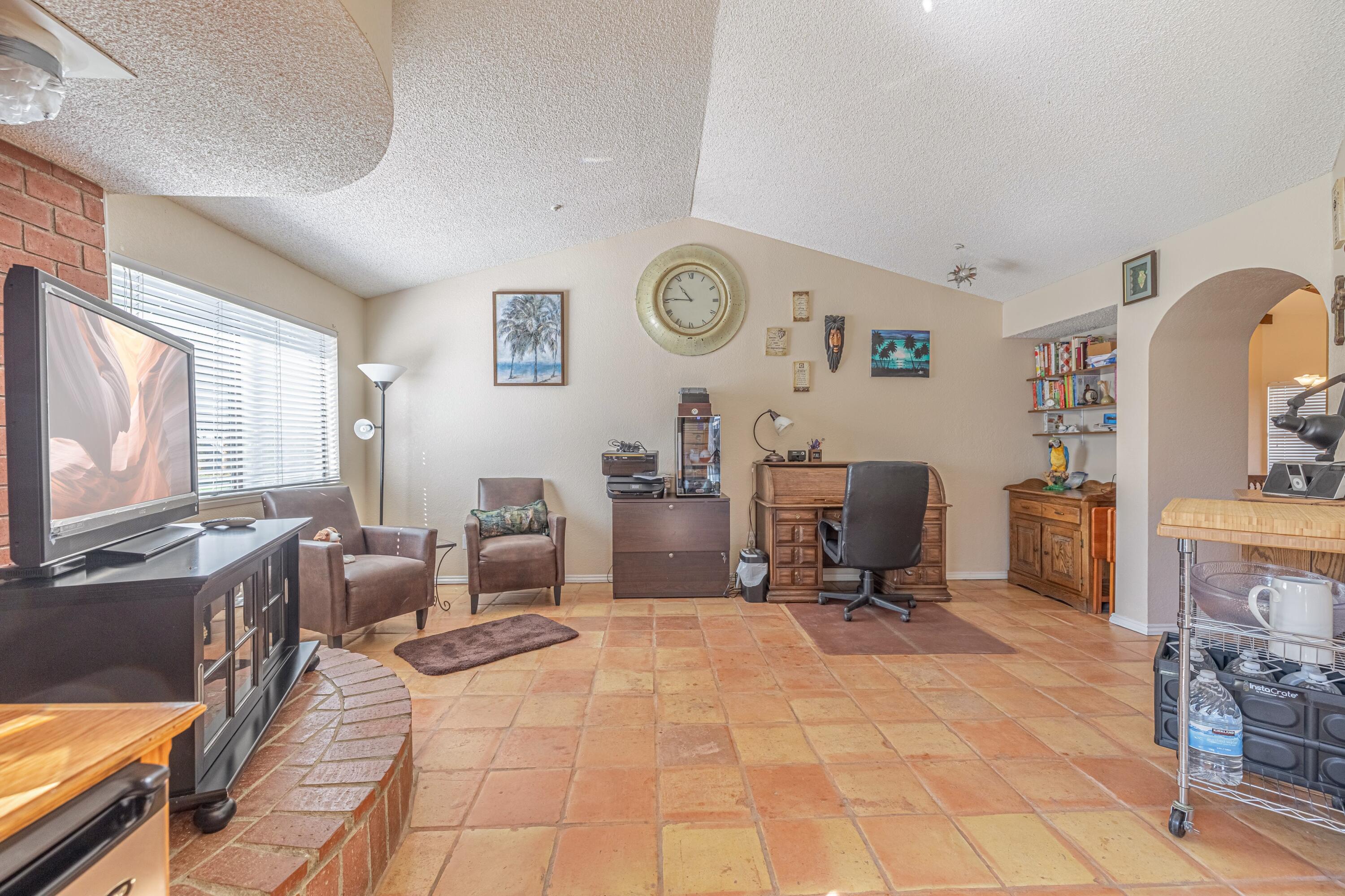 43233 55th Street East Lancaster, CA 93535 - Photo 9 of 46 a view of a livingroom with furniture and a flat screen tv