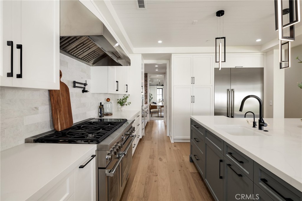 1820 9th Street Manhattan Beach, CA 90266 - Photo 32 of 75 a kitchen with kitchen island stainless steel appliances a sink a stove and a refrigerator