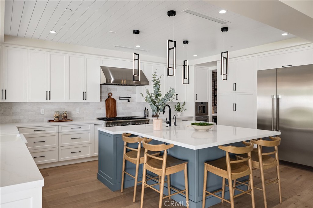 1820 9th Street Manhattan Beach, CA 90266 - Photo 37 of 75 a kitchen with a stove a refrigerator and a dining table