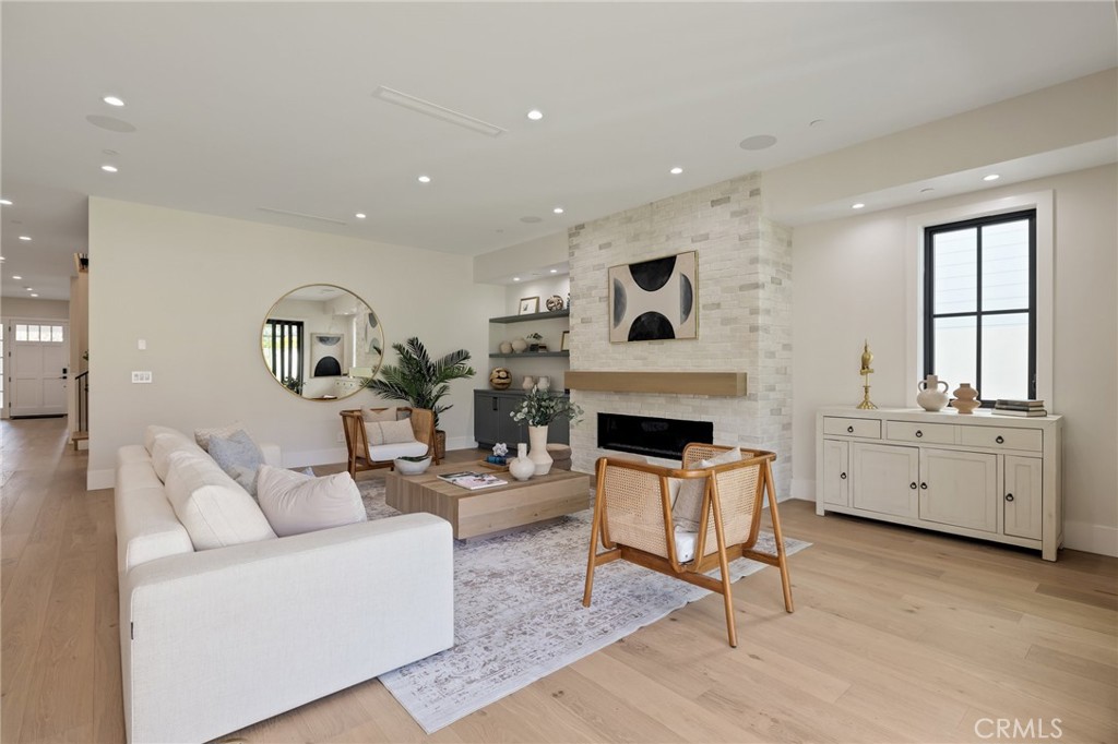 1820 9th Street Manhattan Beach, CA 90266 - Photo 41 of 75 a living room with furniture a fireplace and a table