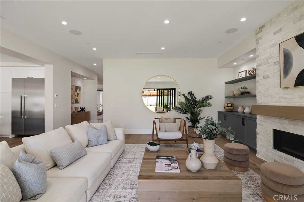 1820 9th Street Manhattan Beach, CA 90266 - Photo 48 of 75 a living room with furniture a fireplace and a potted plant