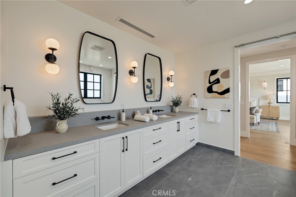 1820 9th Street Manhattan Beach, CA 90266 - Photo 57 of 75 a en suite bathroom with double sink and a mirror