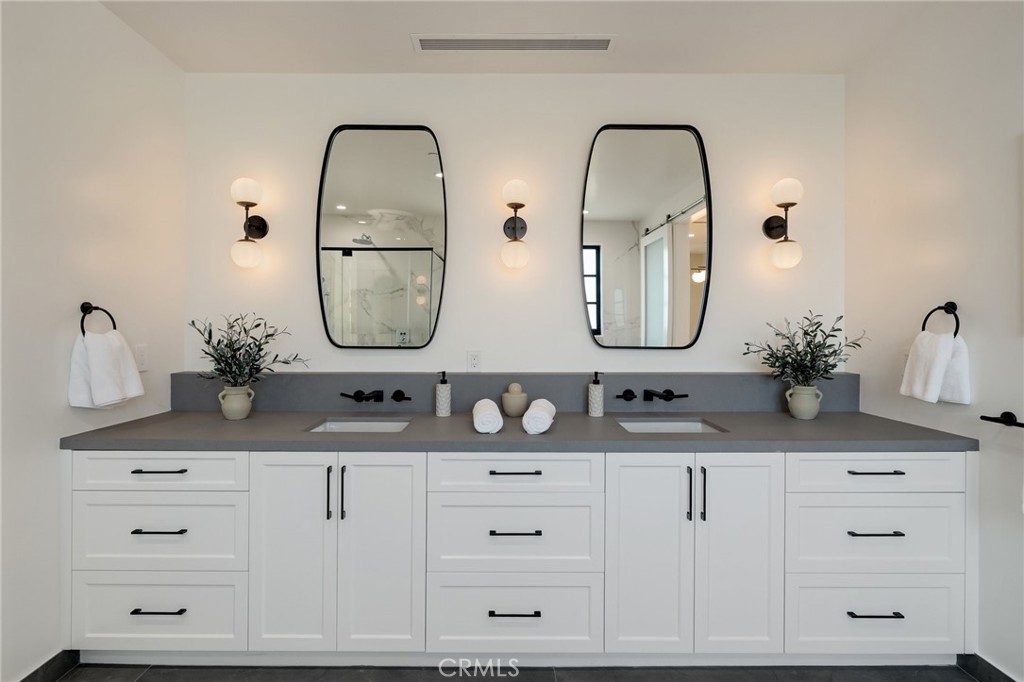 1820 9th Street Manhattan Beach, CA 90266 - Photo 58 of 75 a bathroom with double vanity sinks and a mirror