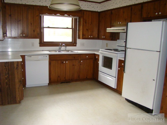 164 New Way Road Boone, NC 28607 - Photo 16 of 17 a kitchen with stainless steel appliances granite countertop a refrigerator a stove a sink and a microwave