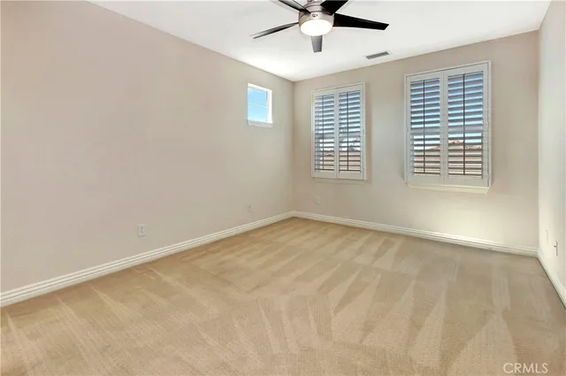 a bathroom with a granite countertop toilet sink and mirror