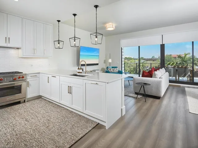 a kitchen with a sink stove and white cabinets