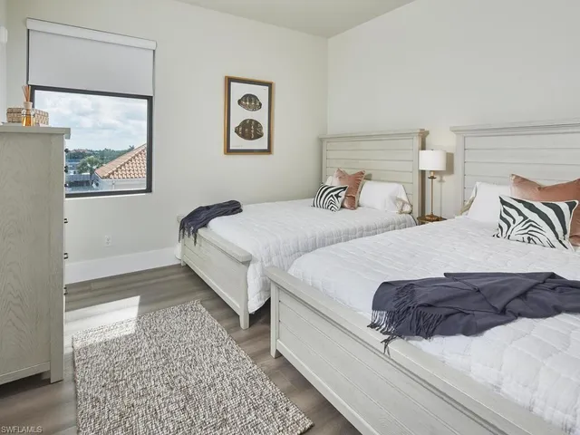 a bedroom with a bed and glass window