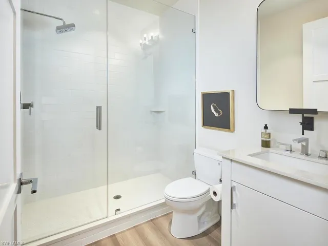 a bathroom with a granite countertop sink toilet and shower