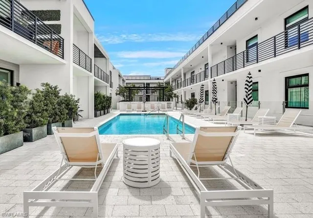 a view of a swimming pool with outdoor seating