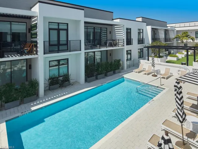a view of house with swimming pool outdoor seating