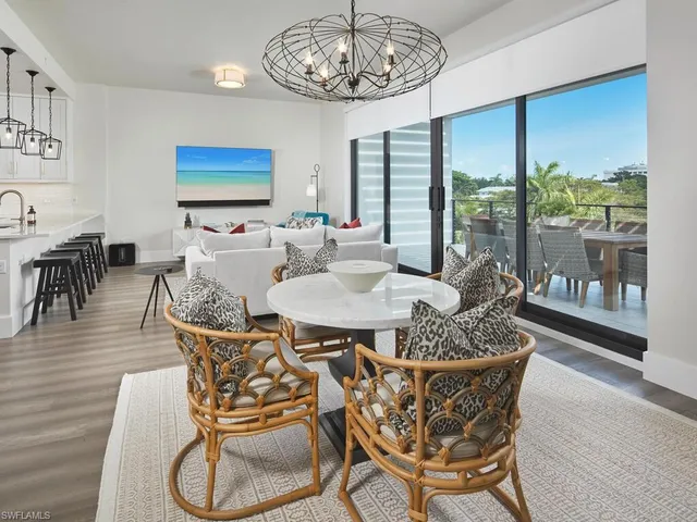 a dining room with furniture a rug and a chandelier