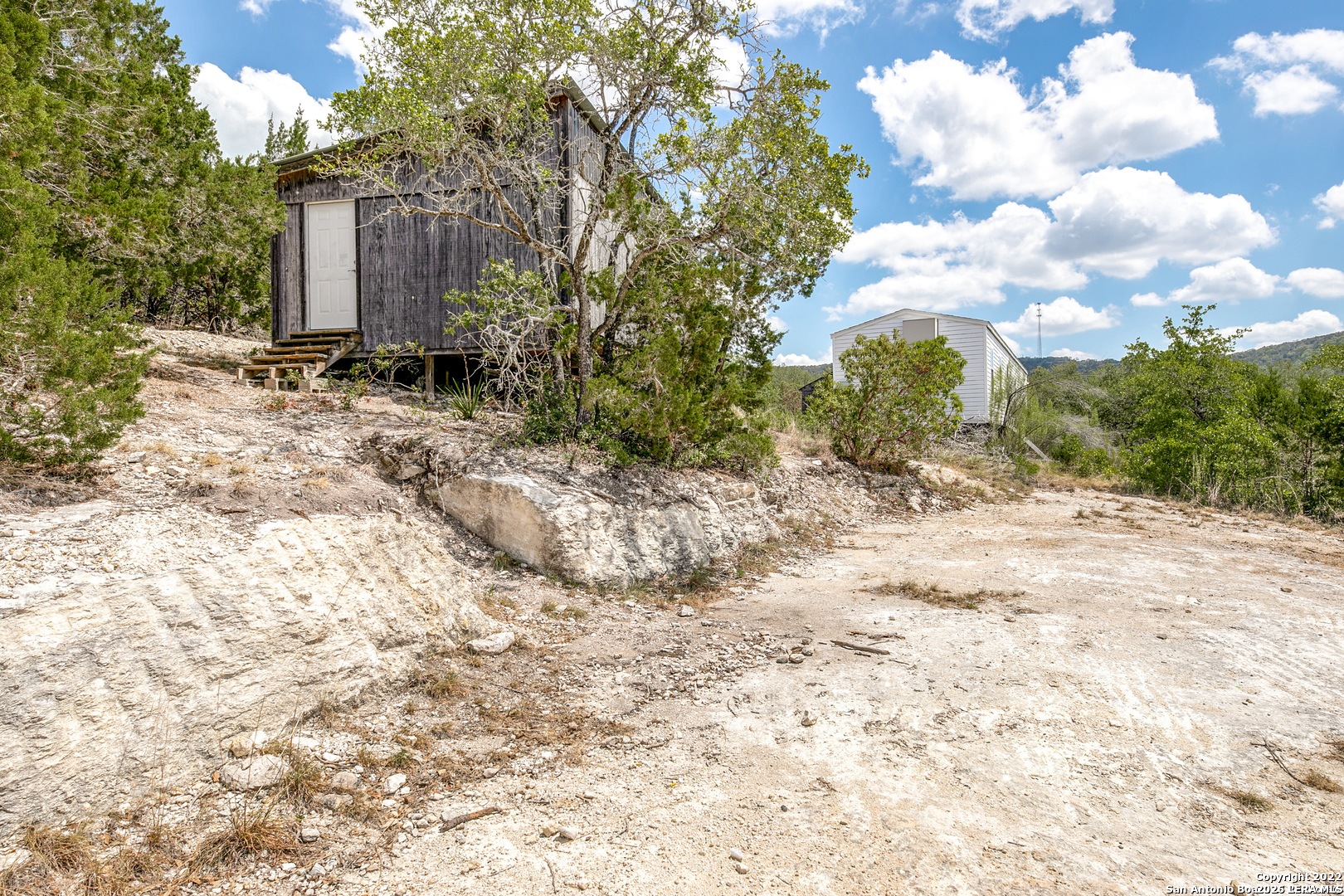 2844 Hidden Valley Road Pipe Creek, TX 78063 - Photo 13 of 30 a backyard of a house with lots of green space