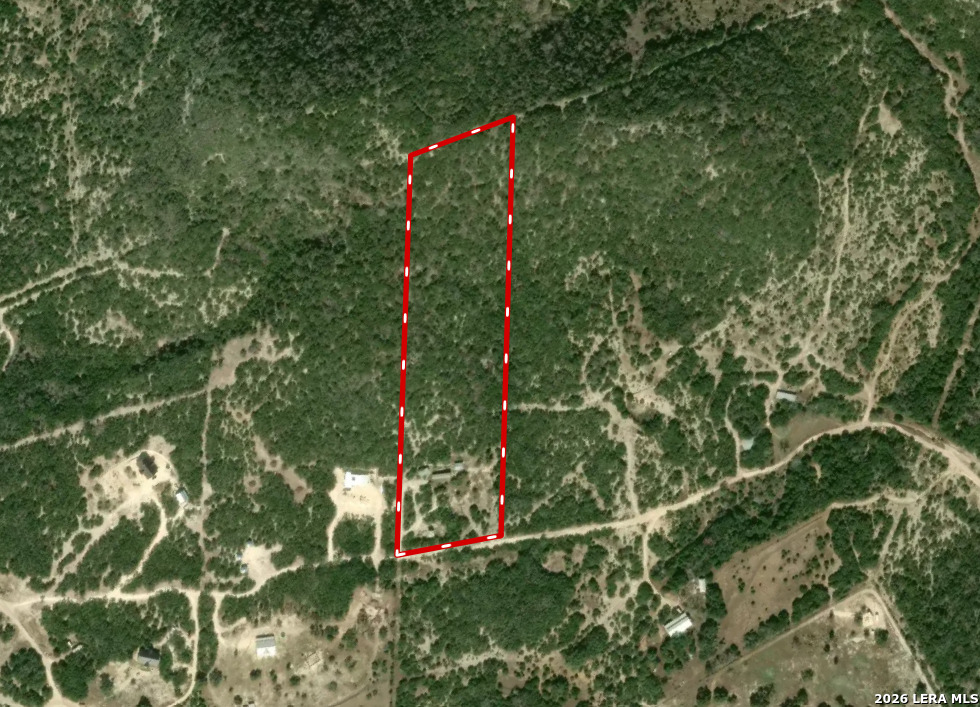 2844 Hidden Valley Road Pipe Creek, TX 78063 - Photo 28 of 30 a backyard of a house with lots of green space and a lake view