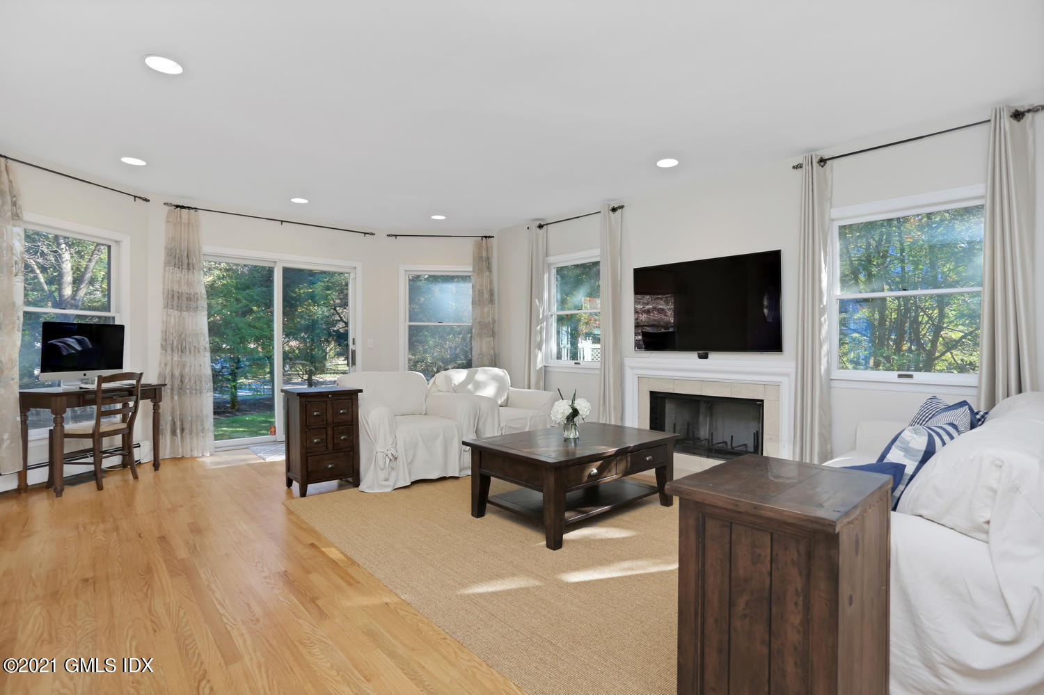 44 Hendrie Avenue Riverside, CT 06878 - Photo 2 of 21 a living room with furniture a fireplace and a flat screen tv