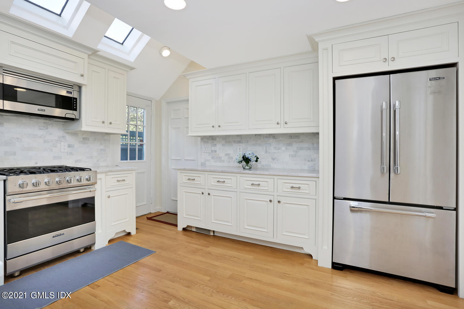 44 Hendrie Avenue Riverside, CT 06878 - Photo 5 of 21 a kitchen with stainless steel appliances white cabinets and a refrigerator