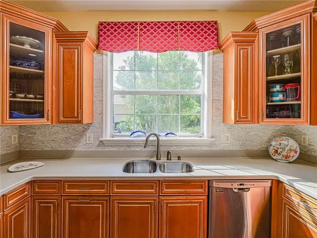 a kitchen with stainless steel appliances a sink and a window