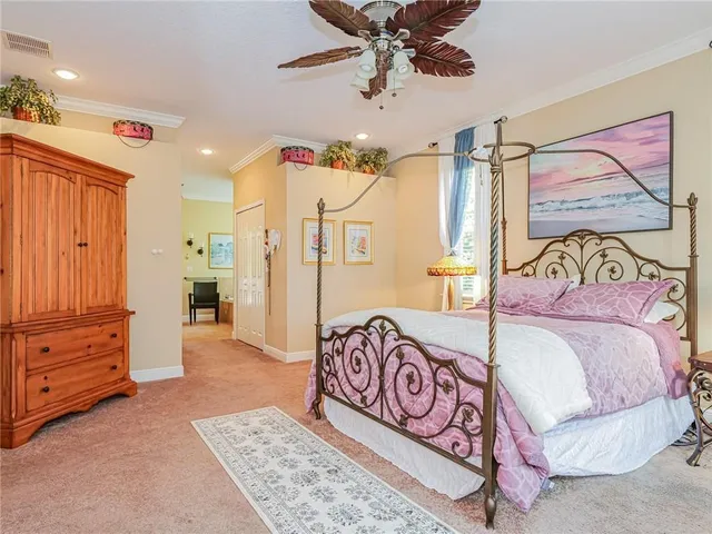 a bedroom with a bed and a painting on the wall