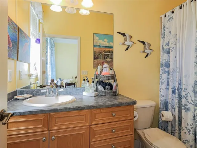 a bathroom with double vanity sink toilet and shower