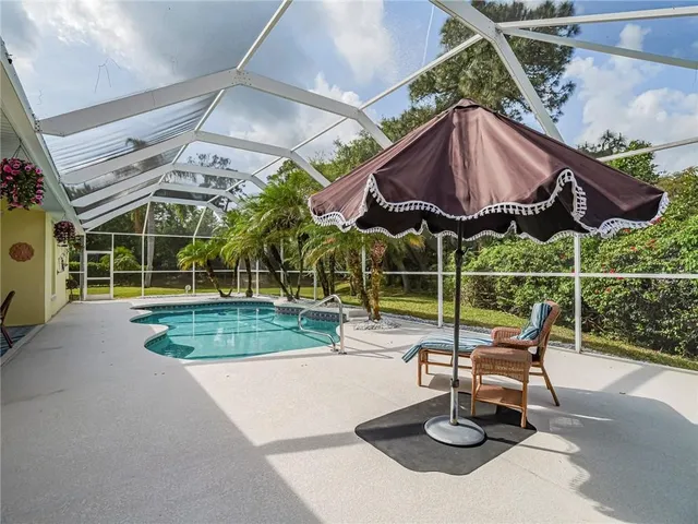 a view of a chair and table in the patio