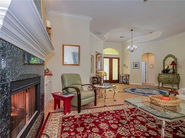 a living room with furniture a rug and a fireplace