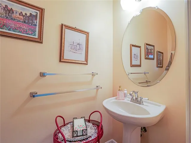a bathroom with a sink mirror and a toilet