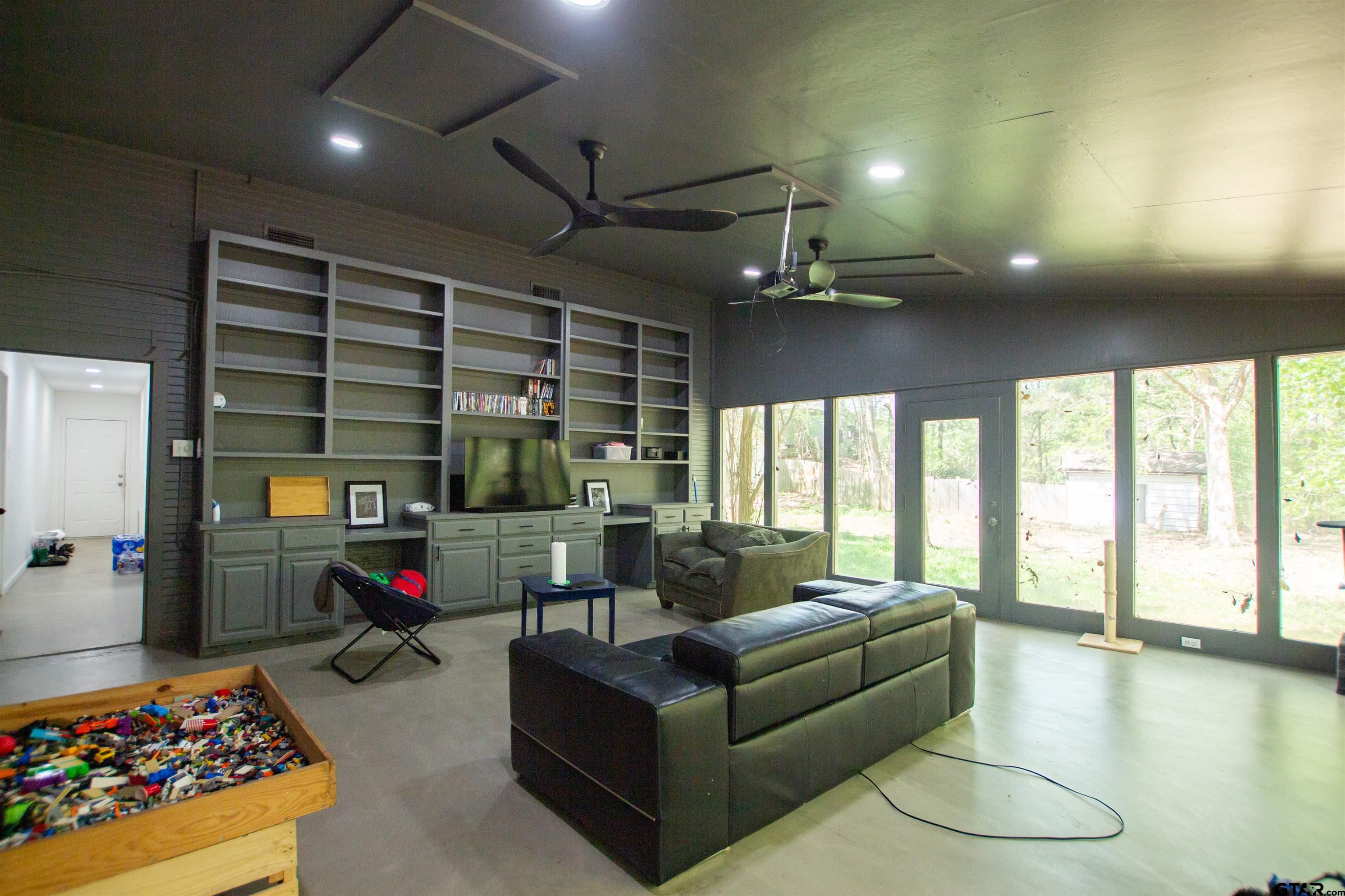 2942 Medlin Road Gilmer, TX 75645 - Photo 11 of 30 a living room with furniture and a floor to ceiling window