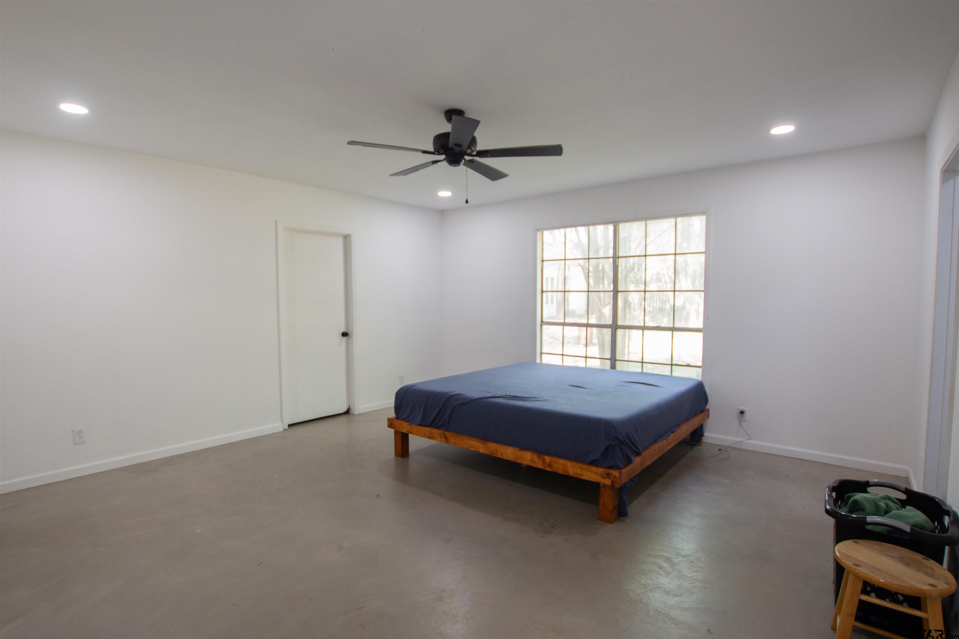 2942 Medlin Road Gilmer, TX 75645 - Photo 13 of 30 a room with a bed and window