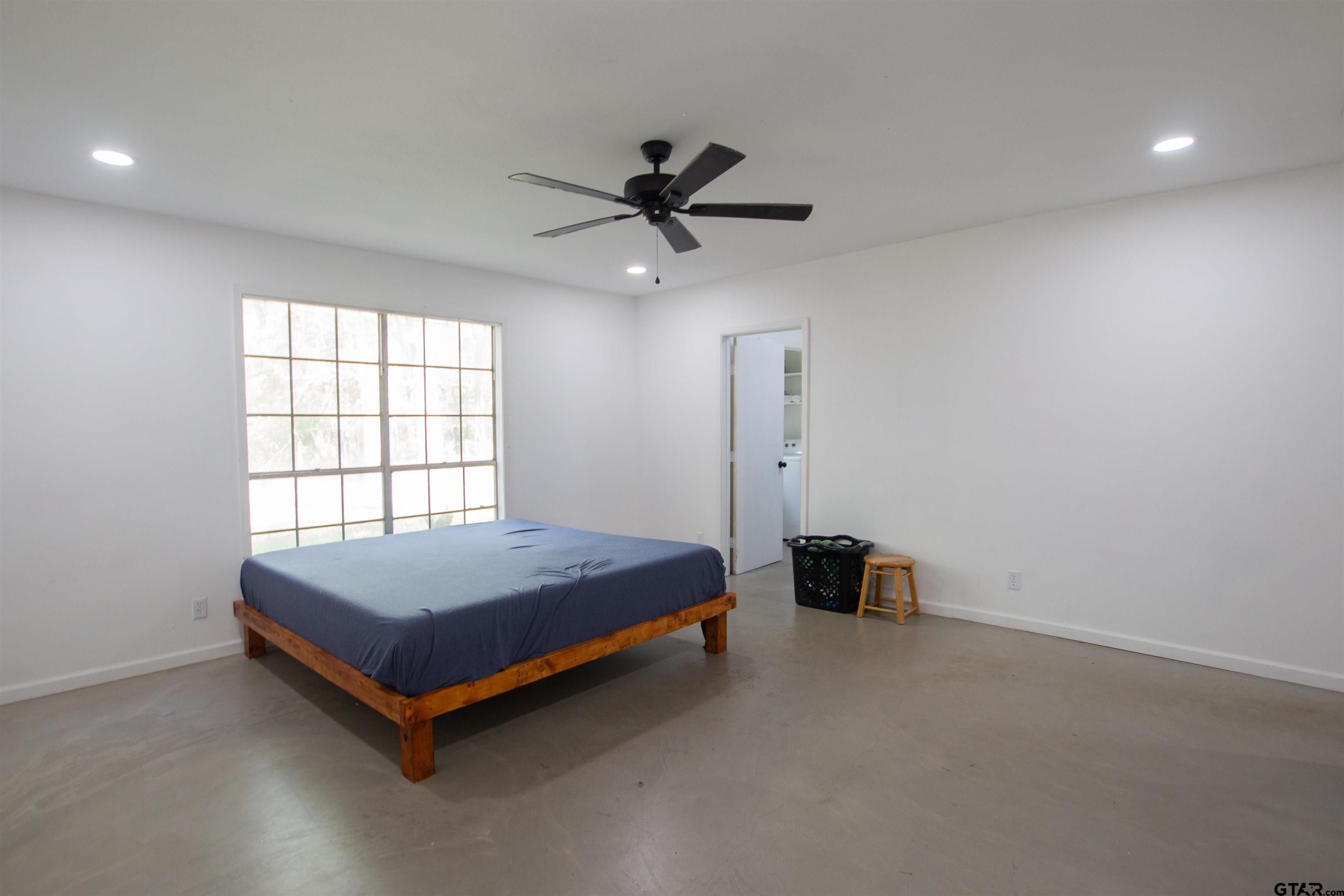 2942 Medlin Road Gilmer, TX 75645 - Photo 14 of 30 a room with a bed and window