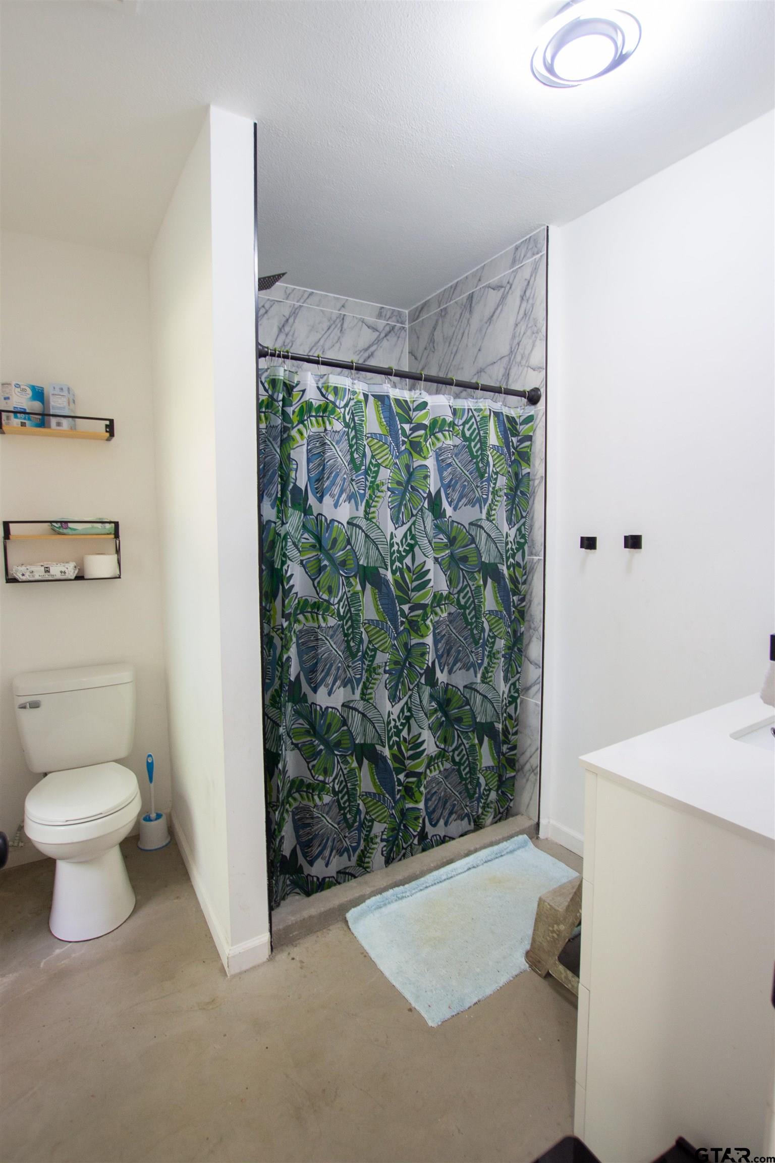 2942 Medlin Road Gilmer, TX 75645 - Photo 15 of 30 a bathroom with a toilet and a sink