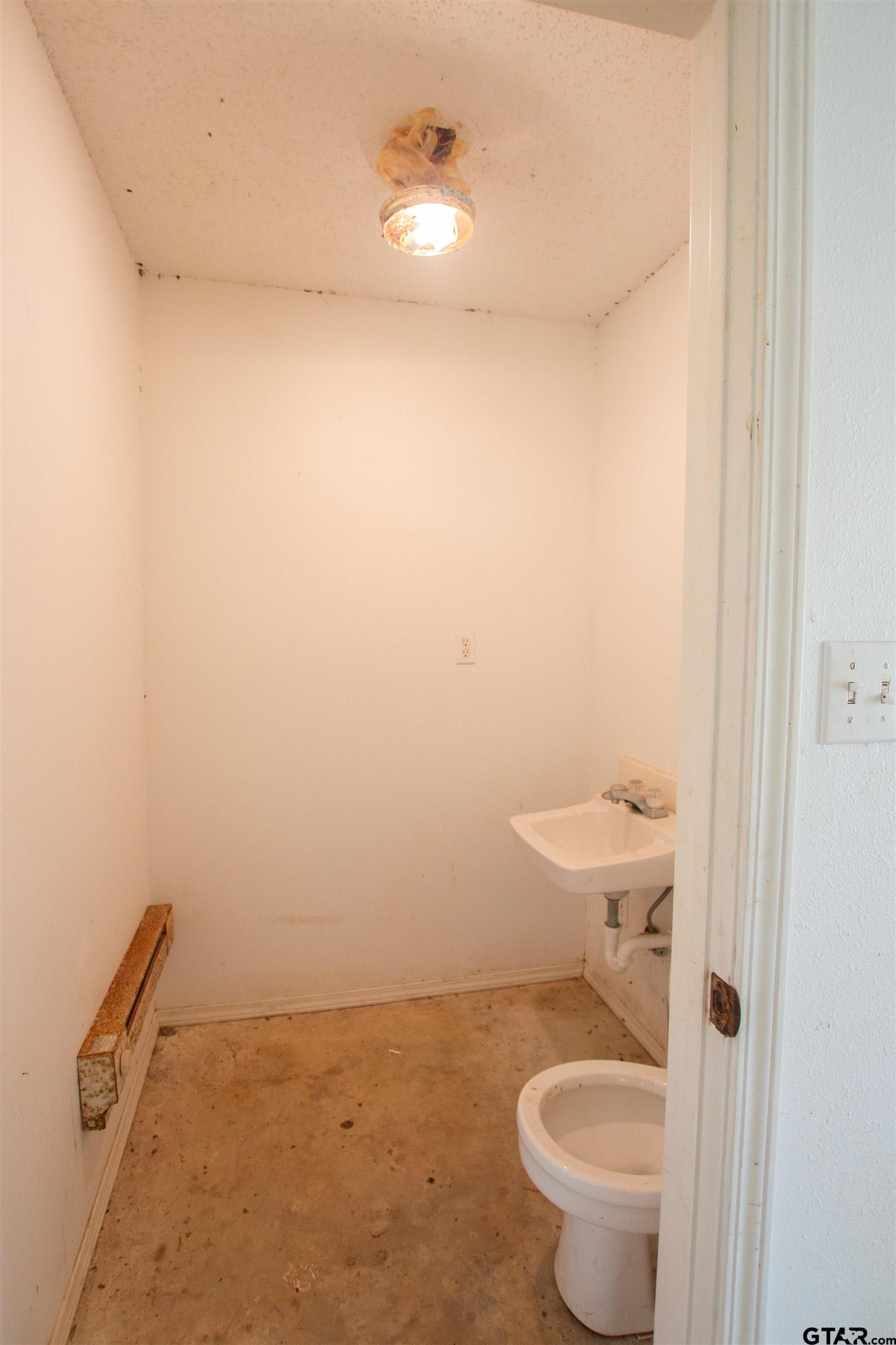 2942 Medlin Road Gilmer, TX 75645 - Photo 30 of 30 a bathroom with a toilet and a shower