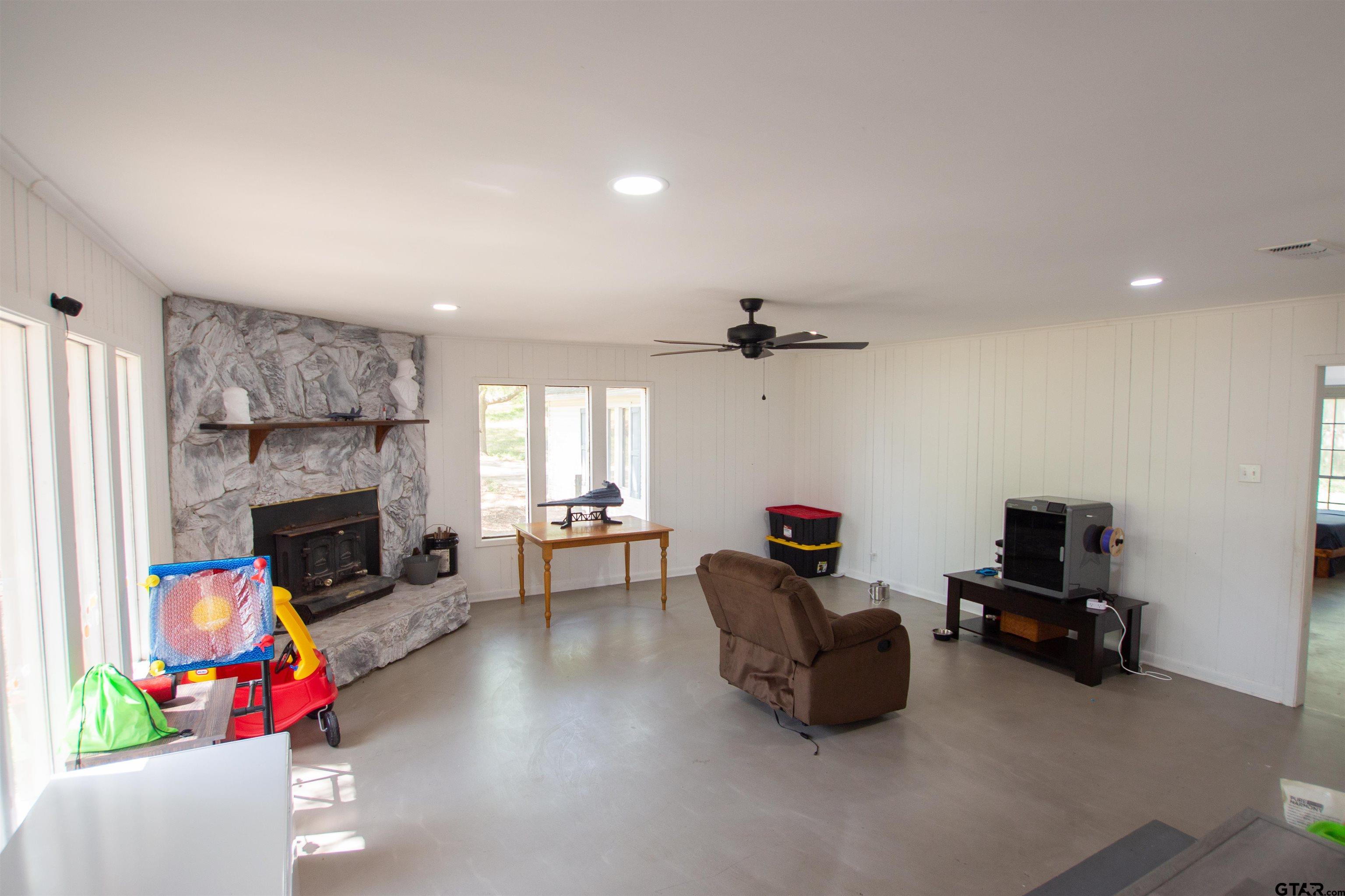 2942 Medlin Road Gilmer, TX 75645 - Photo 3 of 30 a living room with furniture and a fireplace