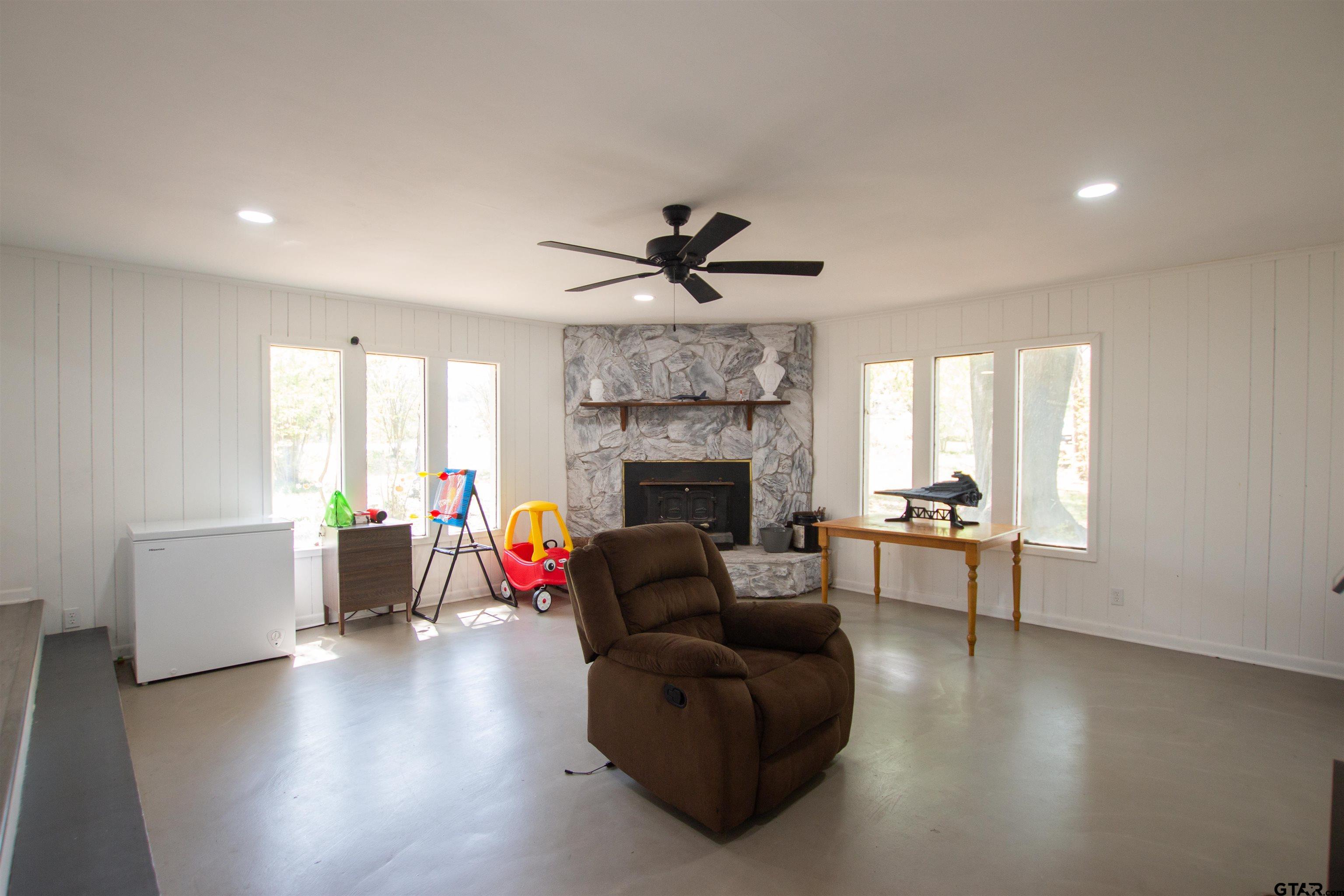 2942 Medlin Road Gilmer, TX 75645 - Photo 5 of 30 a living room with furniture and a fireplace