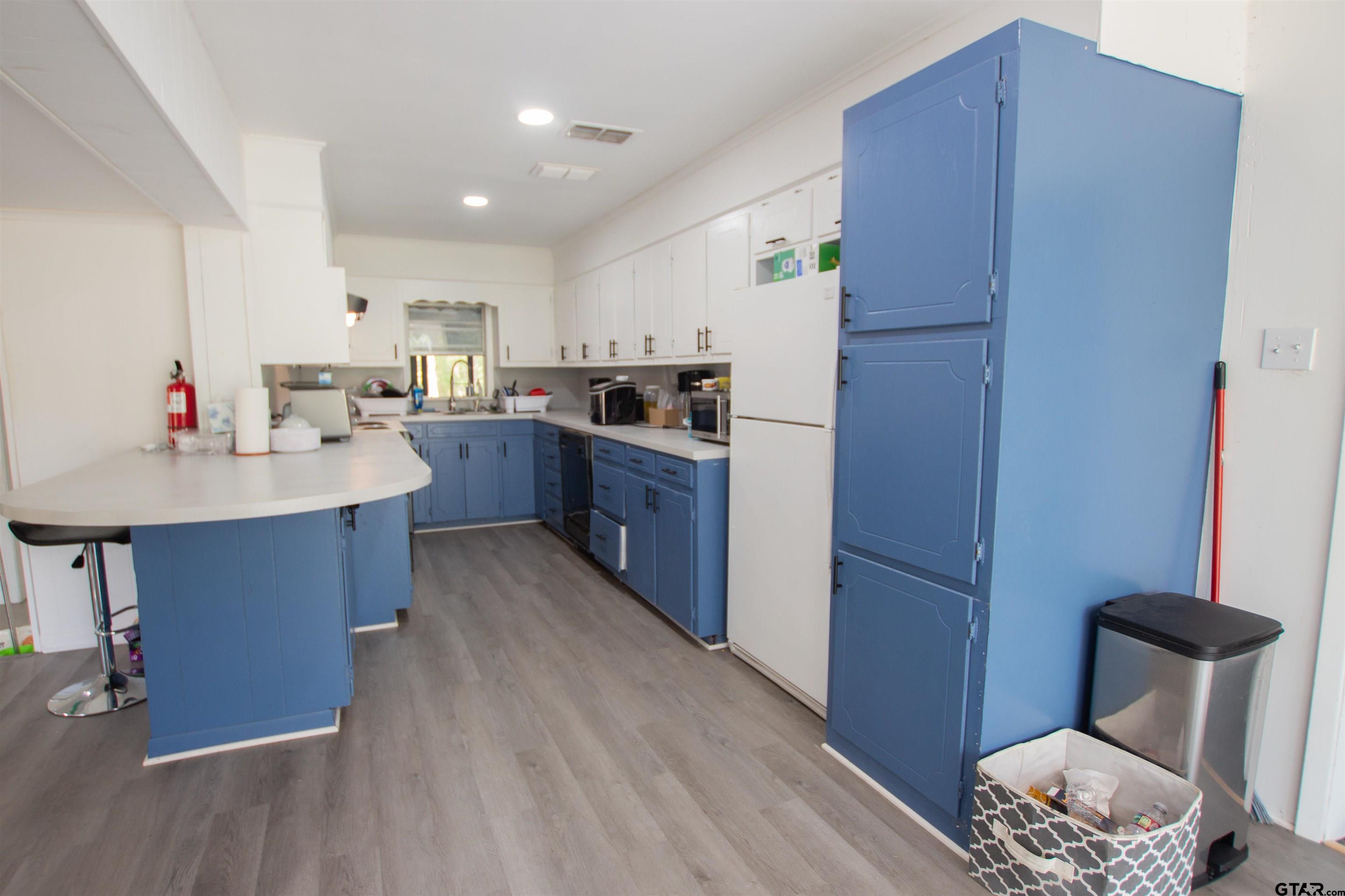 2942 Medlin Road Gilmer, TX 75645 - Photo 6 of 30 a kitchen with a sink cabinets and wooden floor