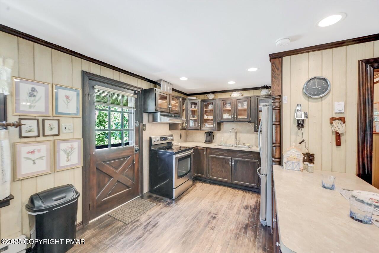 5142 Pine Tree Road Pocono Summit, PA 18346 - Photo 28 of 57 a kitchen with stainless steel appliances kitchen island granite countertop a stove and a wooden floors