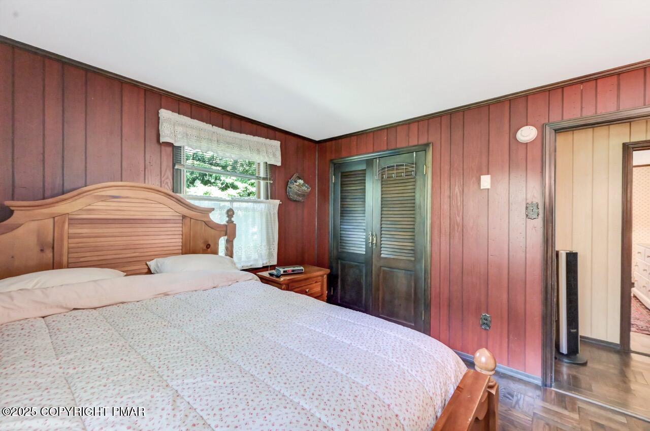 5142 Pine Tree Road Pocono Summit, PA 18346 - Photo 36 of 57 a bedroom with a large bed and a window