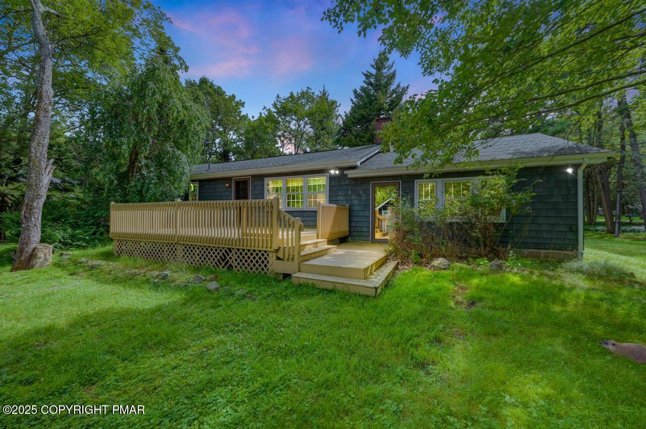 5142 Pine Tree Road Pocono Summit, PA 18346 - Photo 4 of 57 a view of a house with backyard sitting area and garden