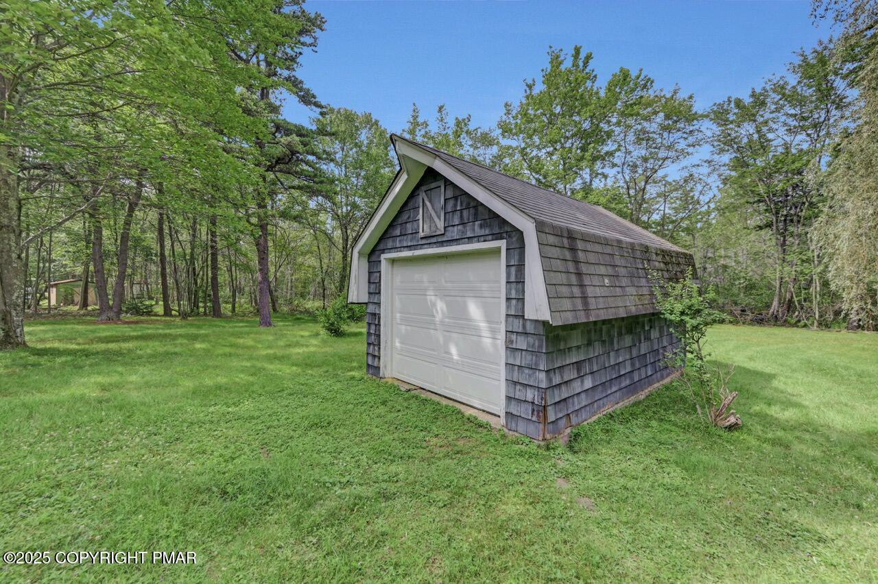 5142 Pine Tree Road Pocono Summit, PA 18346 - Photo 55 of 57 a front view of a house with a garden