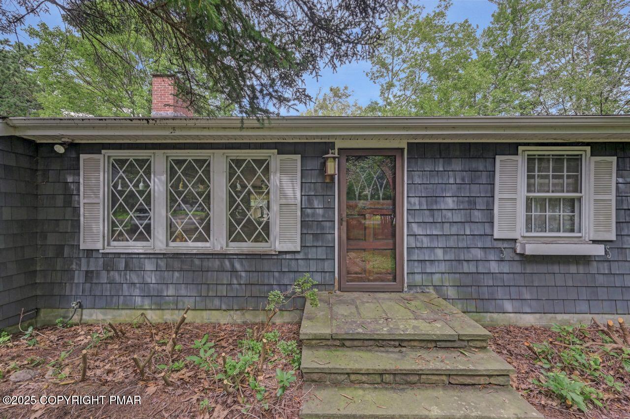 5142 Pine Tree Road Pocono Summit, PA 18346 - Photo 6 of 57 a side view of a house with a window